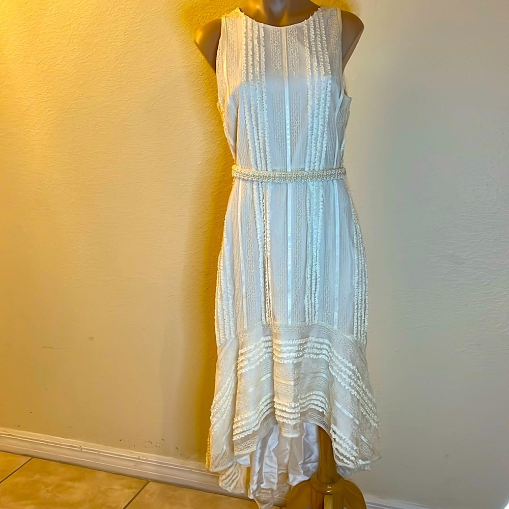 Ivory lace high low peplum sleeveless dress w/ beaded belt. Size 10